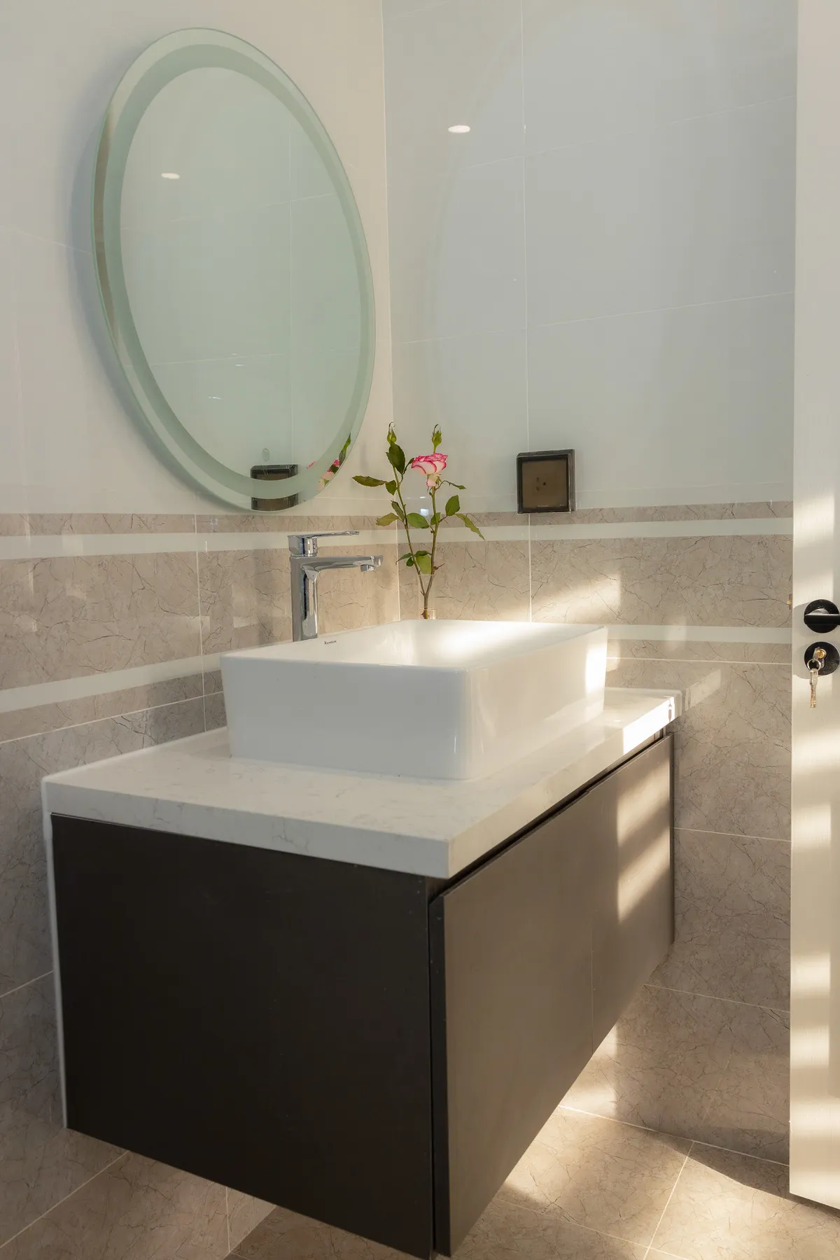 Modern bathroom vanity with a round mirror and wall-mounted cabinet